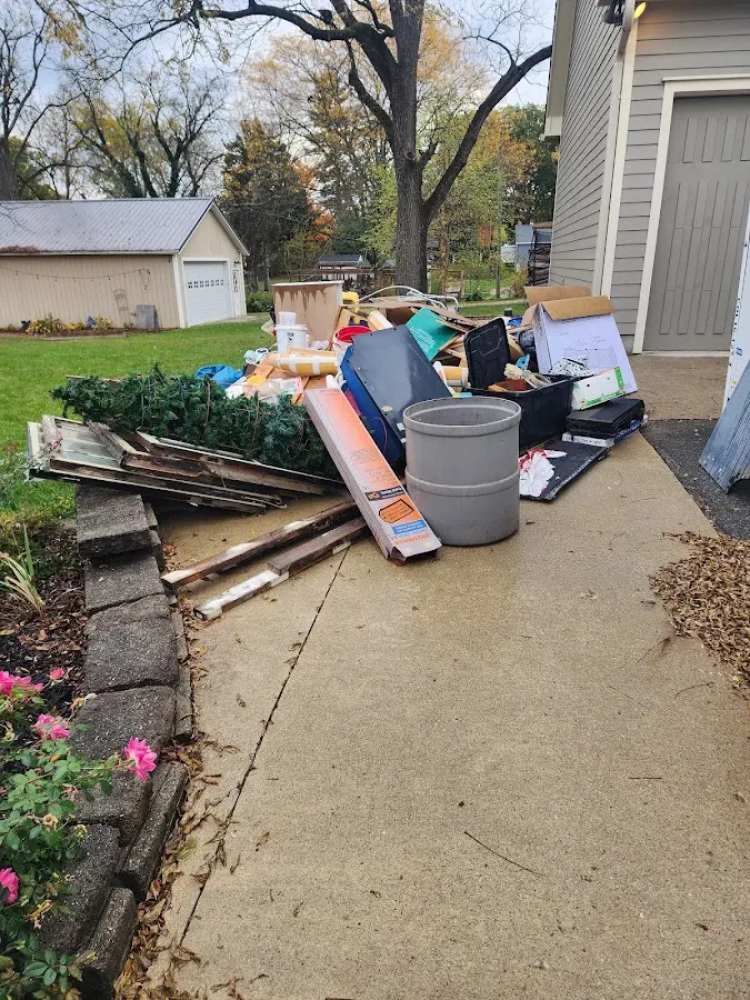 Dumpster being loaded with debris for 12 Yard Dumpster Rental in La Plata